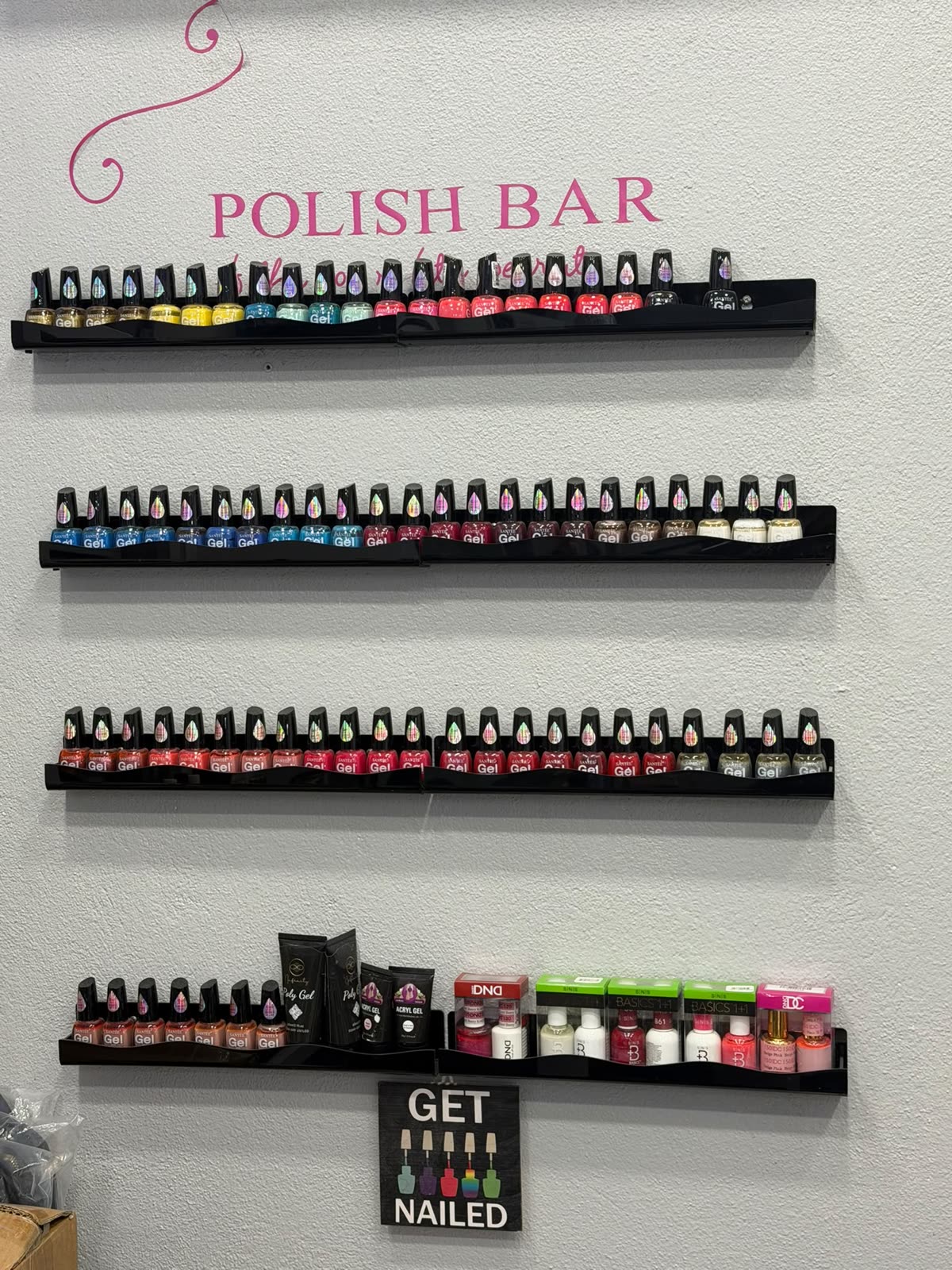 The Polish Bar wall lined with rows of gel polish colours