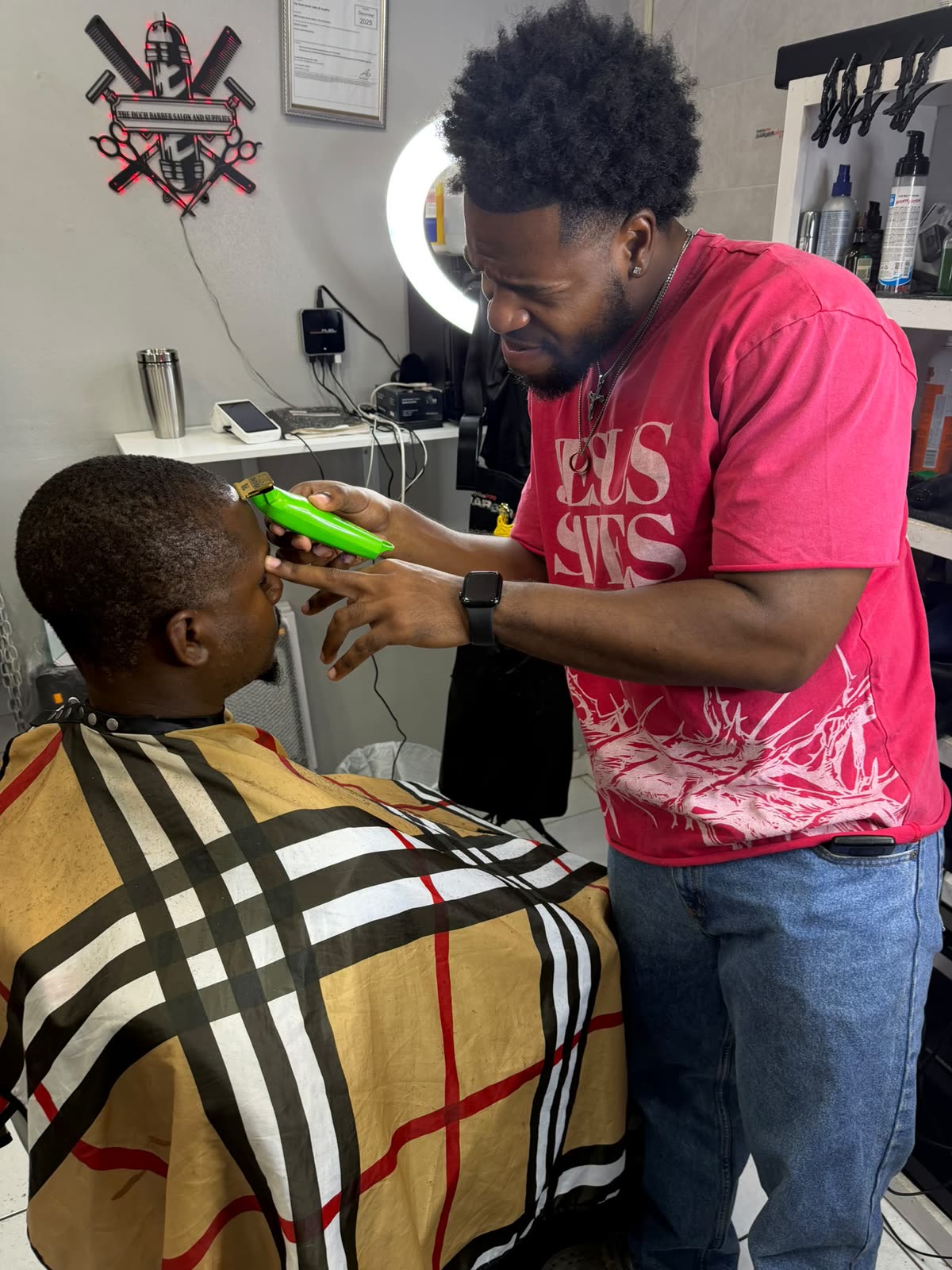 A Duch Barber barber lining up a client's cut